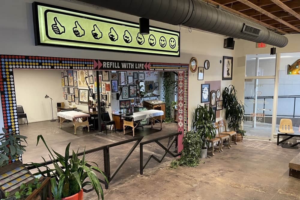 tattoo shop with plants and framed photos