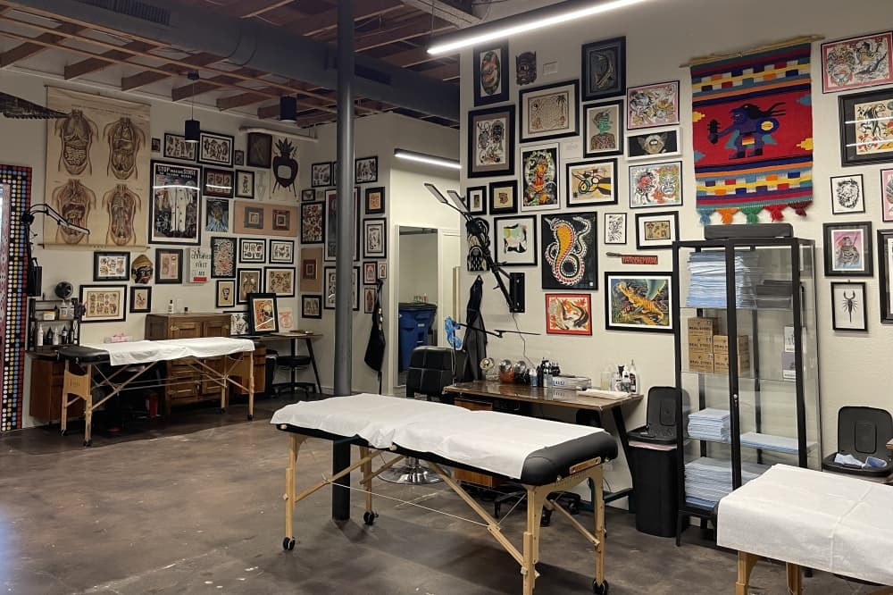 tattoo shop with plants and framed photos