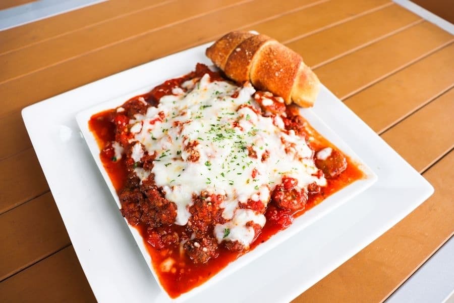 Tubes of pasta are stuffed and baked for the manicotti dish. (Zara Flores/Community Impact)