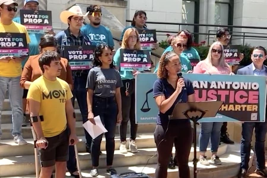 people holding signs at a press conference