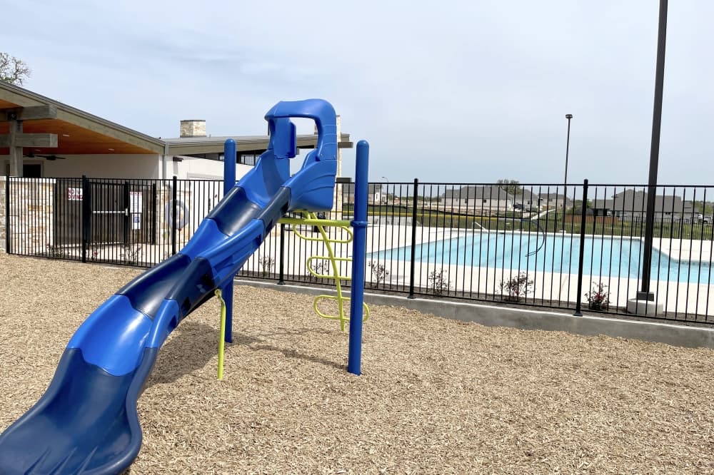 The amenity center has a fenced-in pool and a playground. (Grant Crawford/Community Impact)