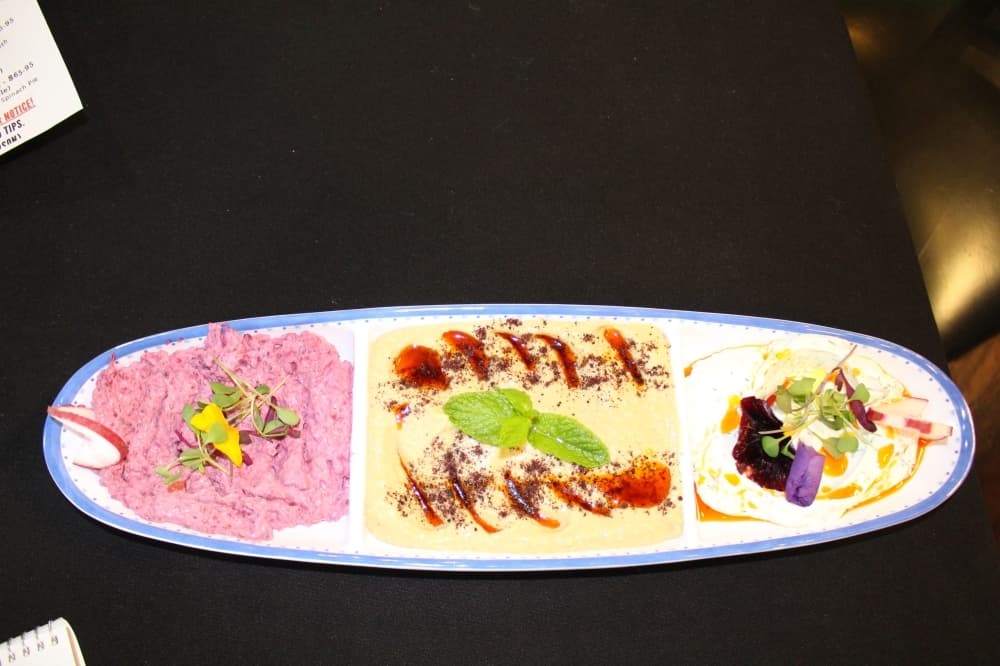 A plate with hummus and olives