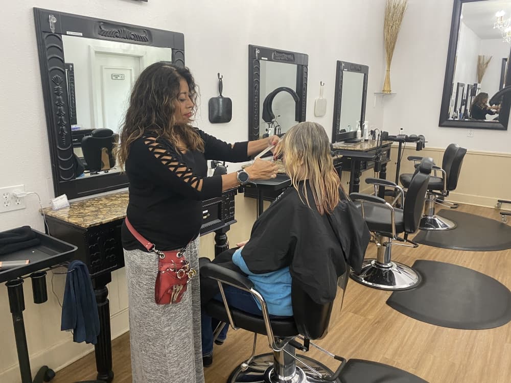 
Co-owner Anna Gonzales works on a client’s hair.