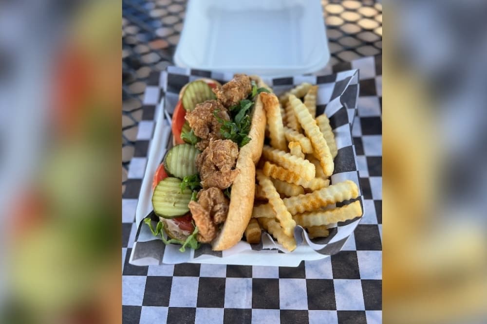 The shrimp po'boy ($13.95) can come blackened or fried with a side of french fries or tater tots. (Zacharia Washington/Community Impact)