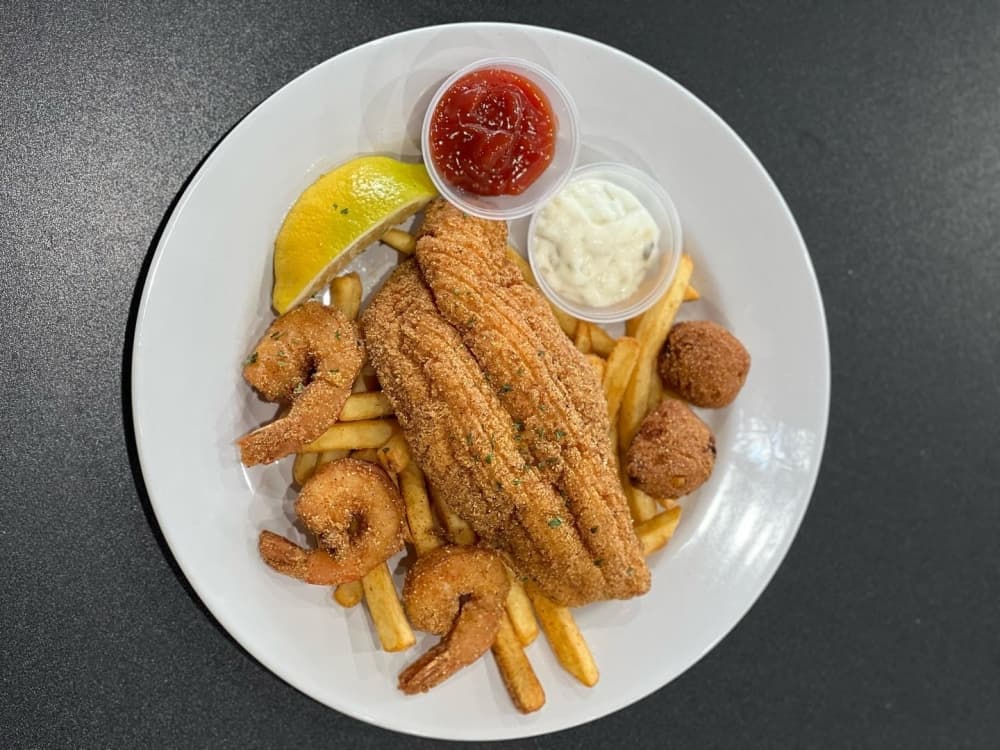 Fish and shrimp combo ($20.99): This dish consists of two pieces of fried fish, six pieces of fried shrimp, fries and two hushpuppies. (Courtesy Kid Kreole Kooking) 