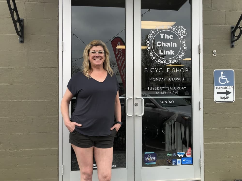 Chain Link Bicycle Shop owner Seana Rousseau stands in front of the store. 