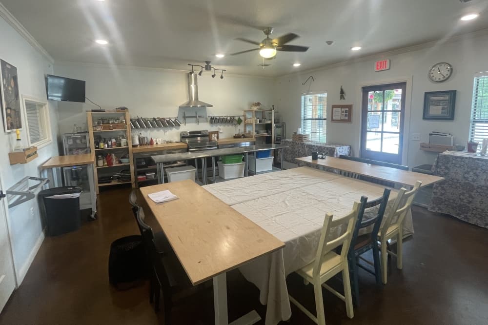 Sanctuary Holistic Kitchen's classroom space includes tables, an oven and cooking utensils. 