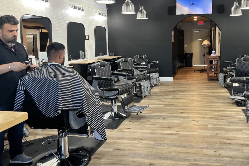 Owner Wisam Kobaissi cuts a clients hair at The Lounge Barber in Leander
