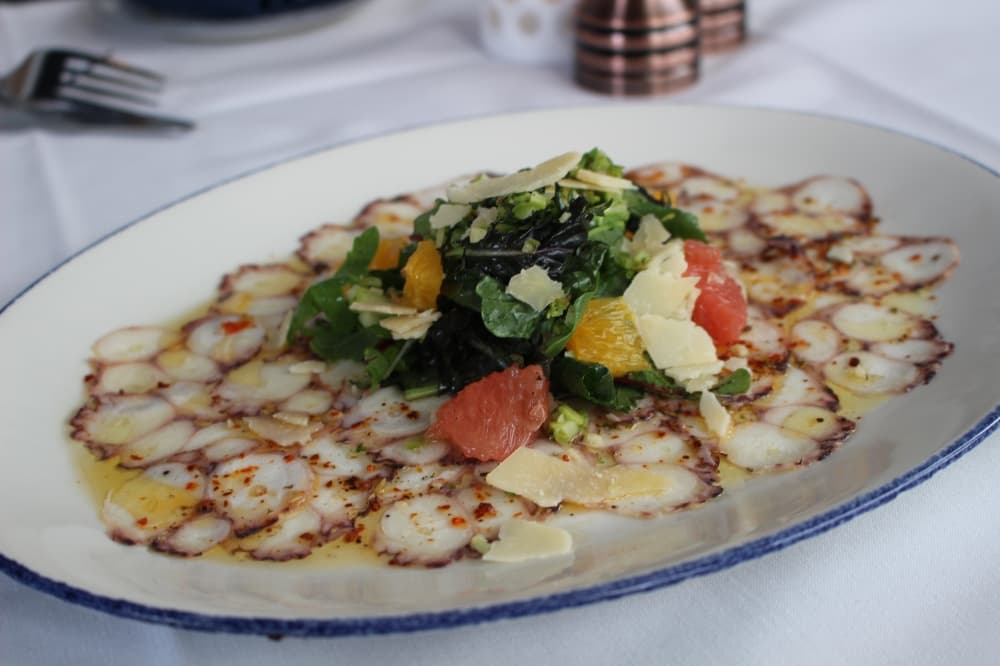 Octopus carpaccio ($XX) is served with thinly sliced octopus and a refreshing arugula salad.