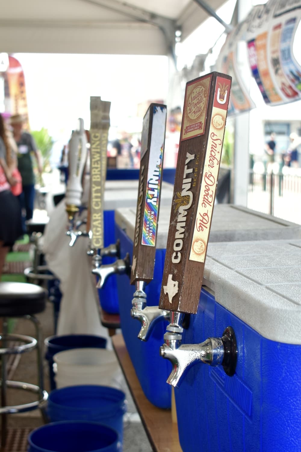 Taps line the tent at a Craft Brew Experience. (Hannah Johnson/Community Impact)