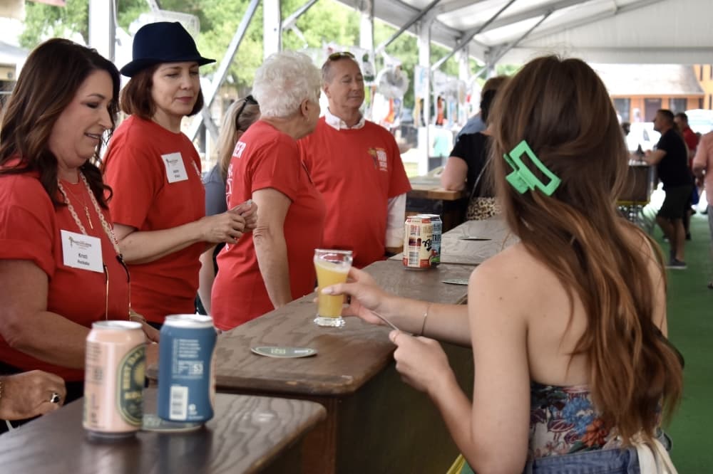 a woman gets a drink at a festival bar