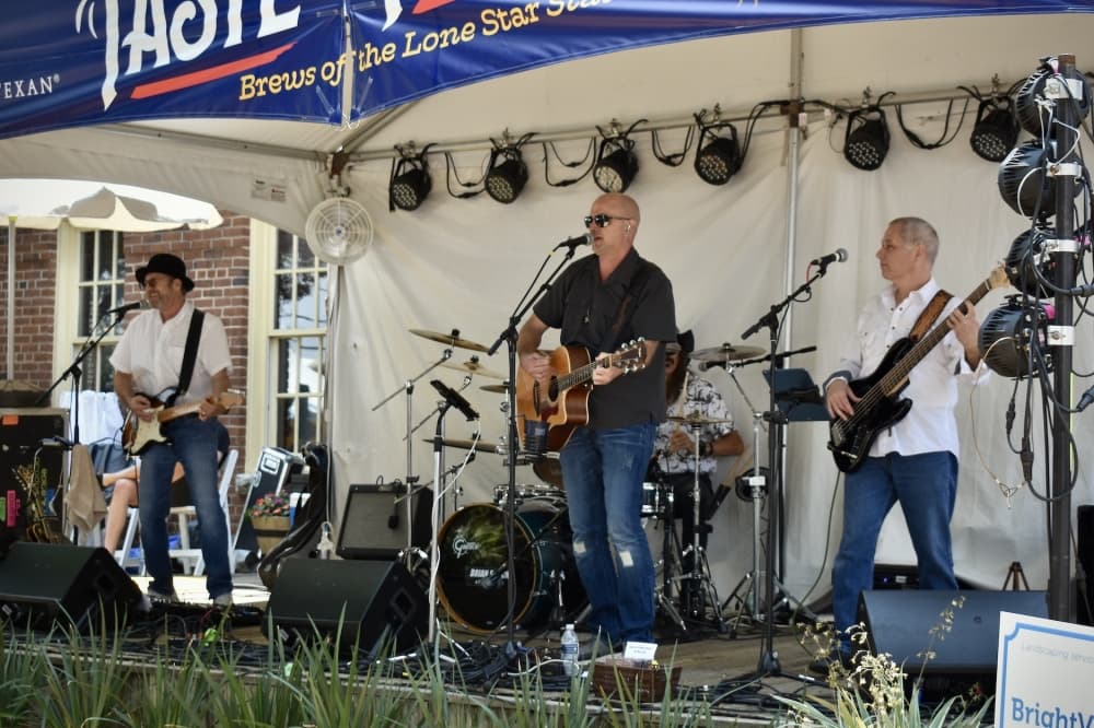 Brian Shuck and The Local Legends play in the A Taste of Texas area in Liberty Park. (Hannah Johnson/Community Impact)