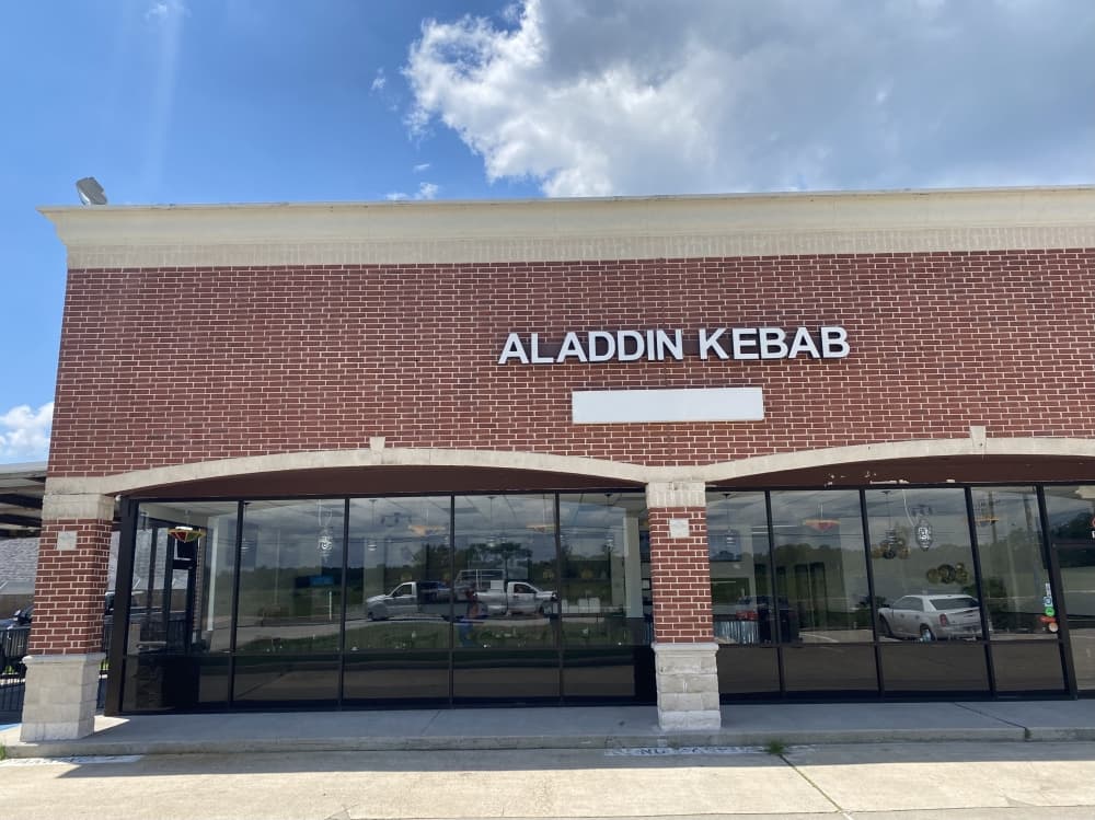 Aladdin Kebab House, 13721 FM 1097, is a brick building displaying the business name