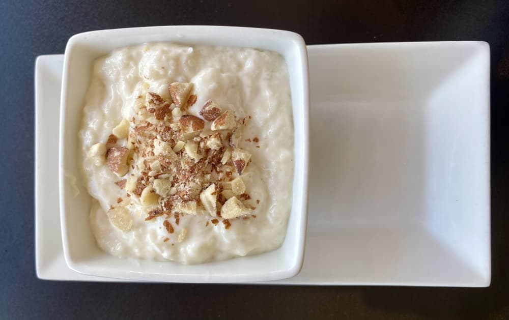 Kheer Rice Pudding is a rice, sugar and milk flavored mixture with spices, nuts and rose water. 