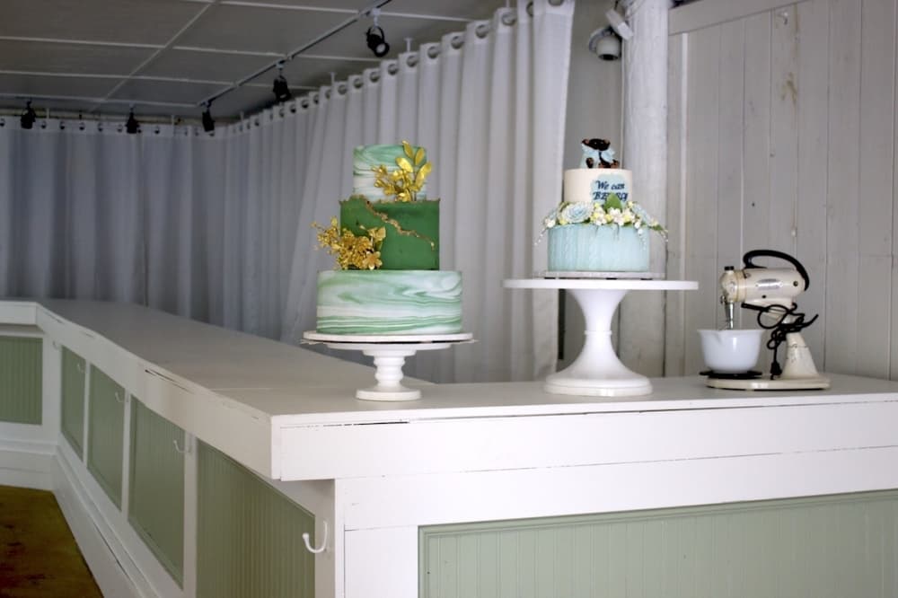 intricately decorated cakes sit on a counter