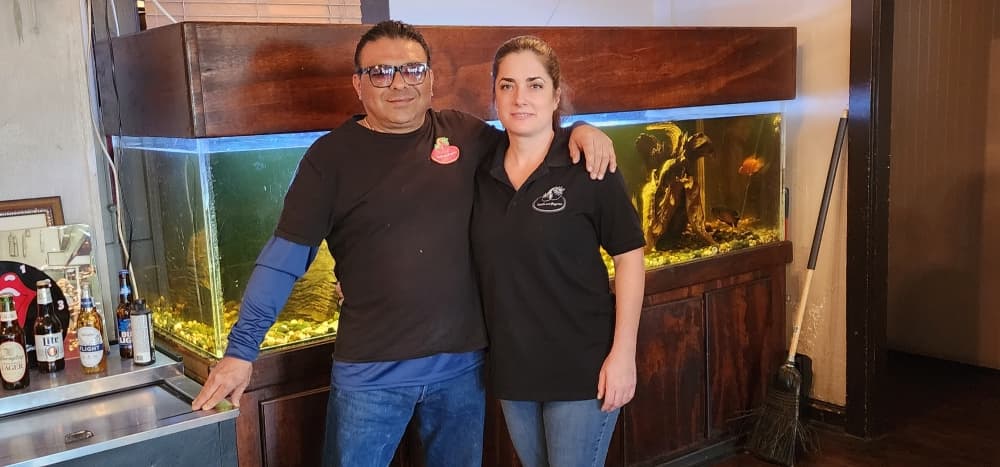 Carl Garza (left) opened Catalano's Pizzeria in 2002. His girlfriend, Sarah, works alongside him. (Jarrett Whitener/Community Impact)