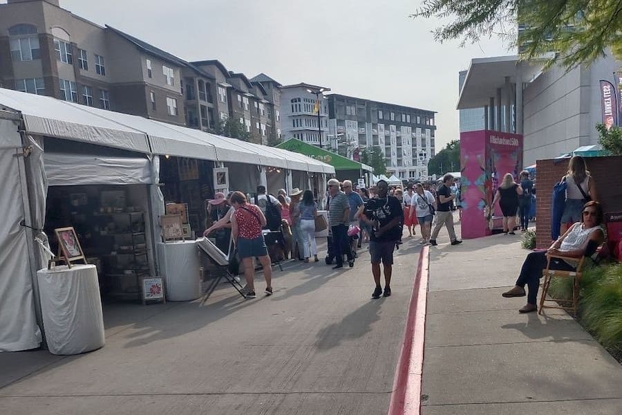 Tents filled with local goods aligned down a street.