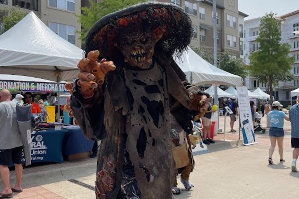 Costumed performer walks around during Wildflower festival
