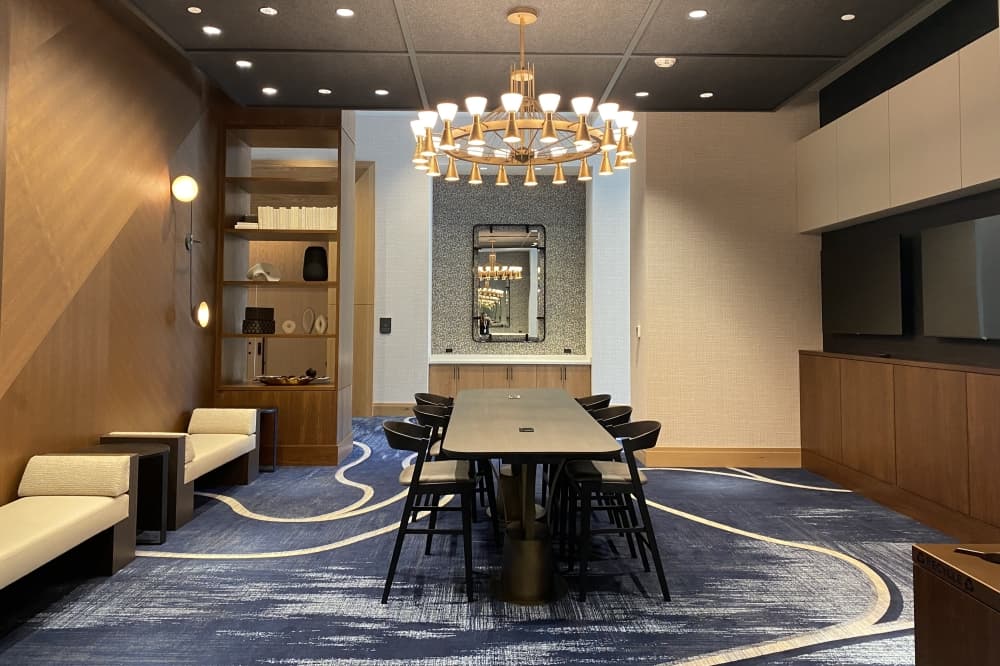 a room with a chair and tables 