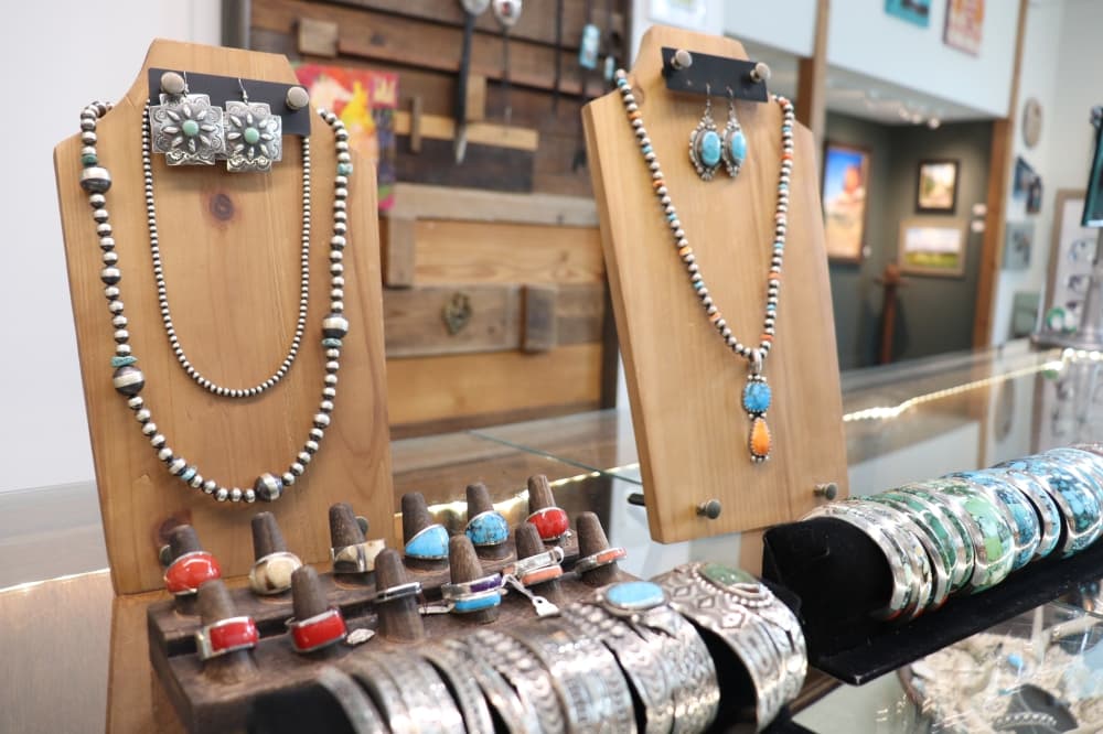 Necklaces, bracelets, rings and other jewelry items are displayed and for sale at the gallery. (Zara Flores/Community Impact)