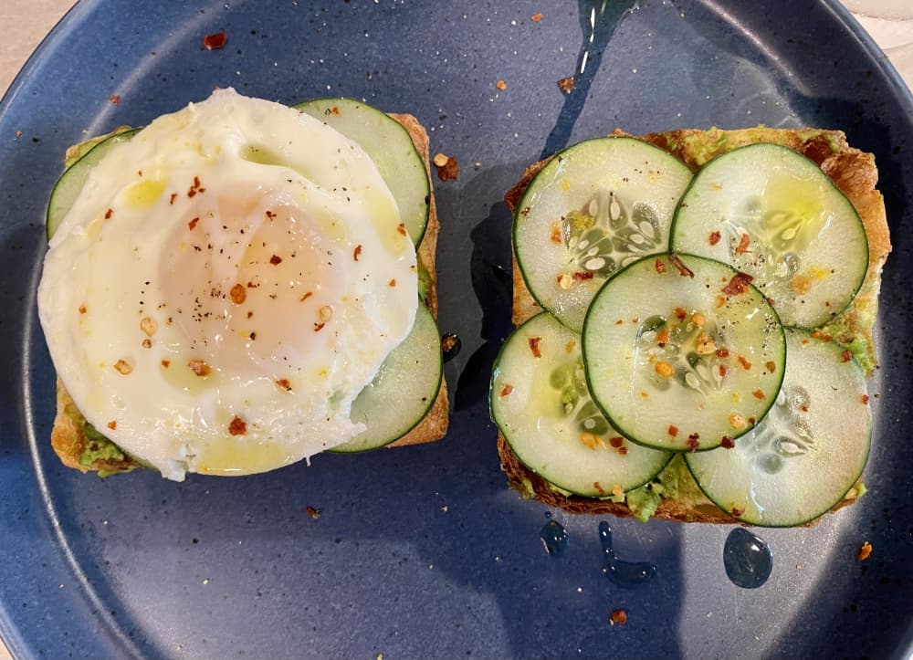 Simona’s avocado toast with poached egg ($18) is served with two pieces of toast topped with a poached egg, avocado, olive oil, cucumber and chili flakes. (Cassandra Jenkins/Community Impact)