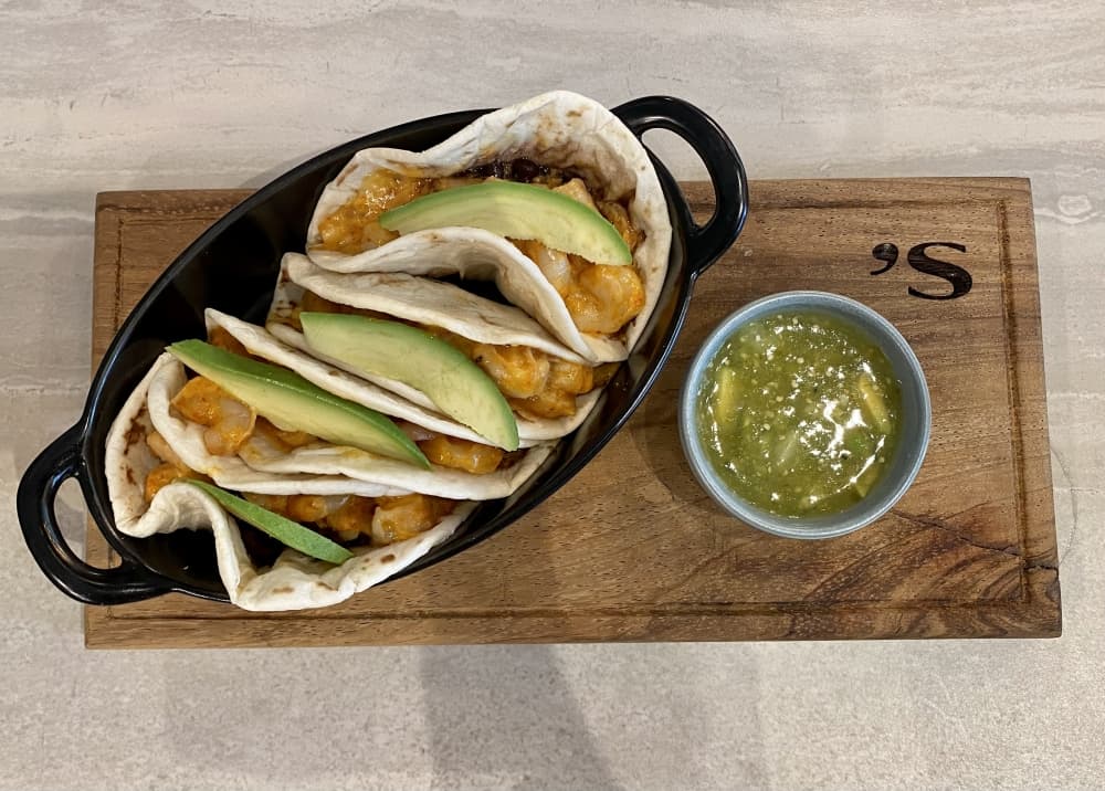 The shrimp tacos ($24) are four flour tortillas with shrimp, chipotle-mayo, fresh avocado and black beans. (Cassandra Jenkins/Community Impact)
