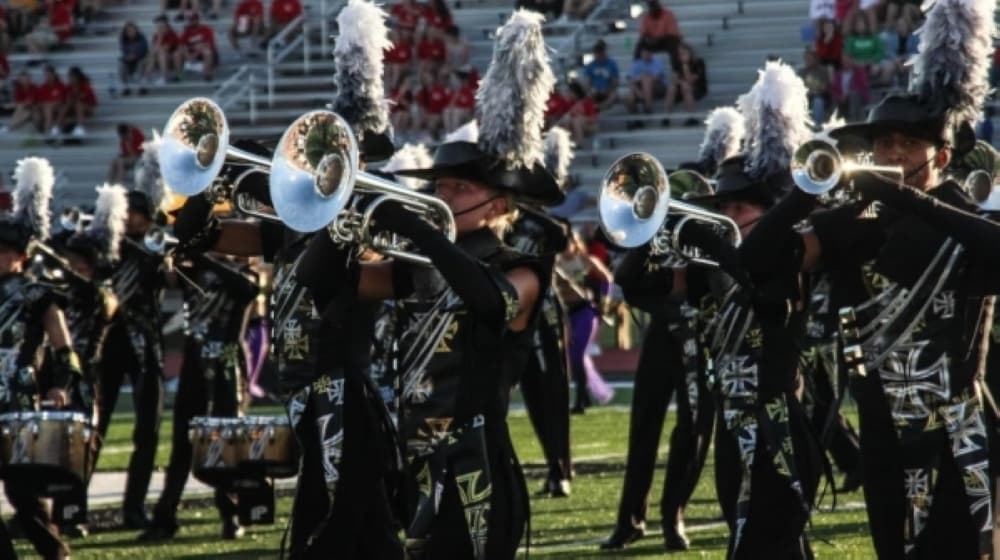 Marching band members playing instruments
