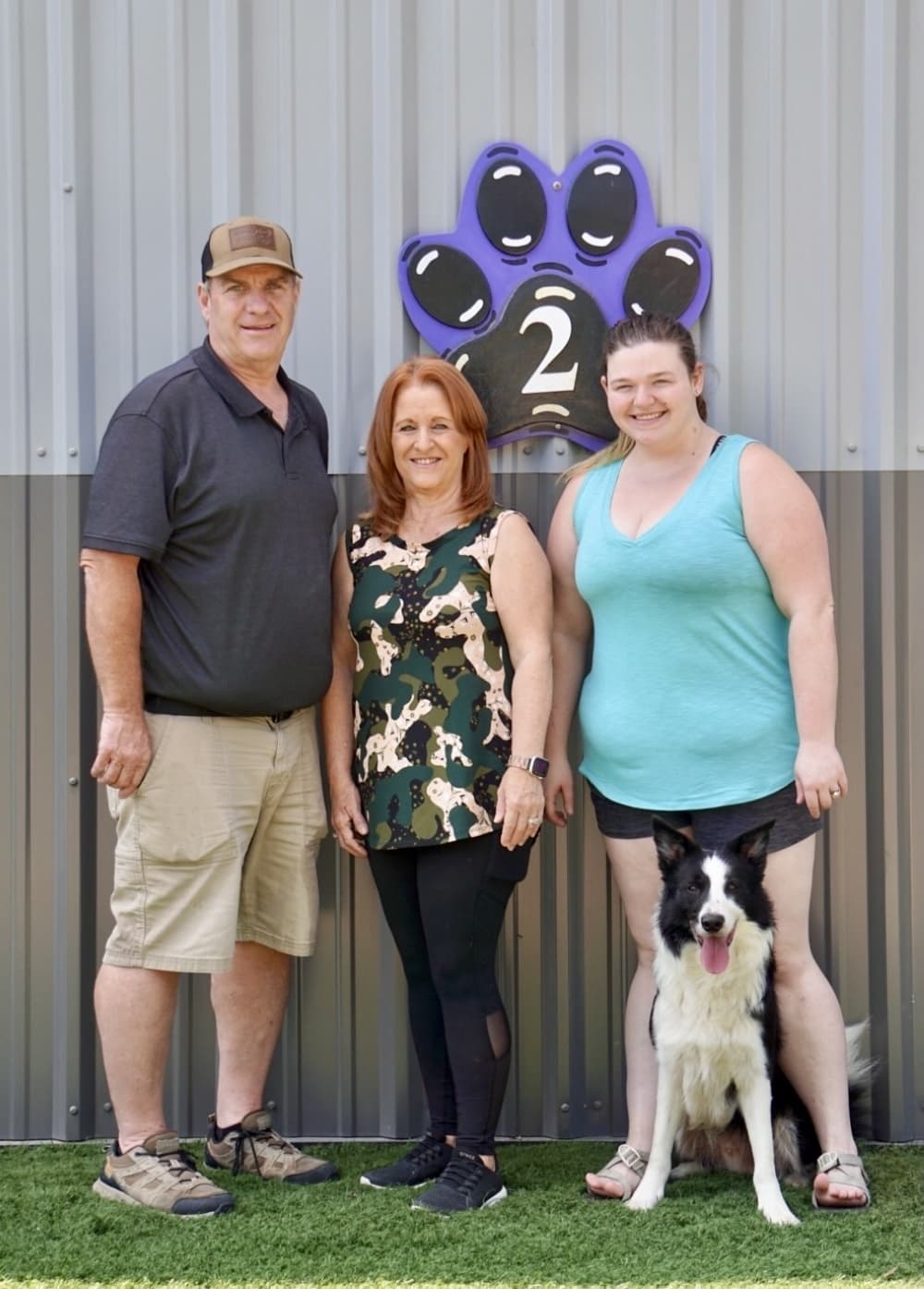Dan Lindquist, left, and wife Monica, center, pose with trainer Deva Wilson and dog Panda outside Dog Gone Fun Agility training center. (Cassandra Jenkins/Community Impact)