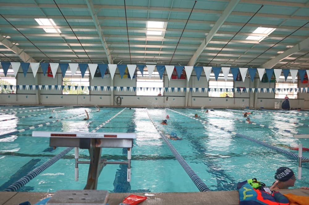 indoor Olympic-sized swimming pool with flags