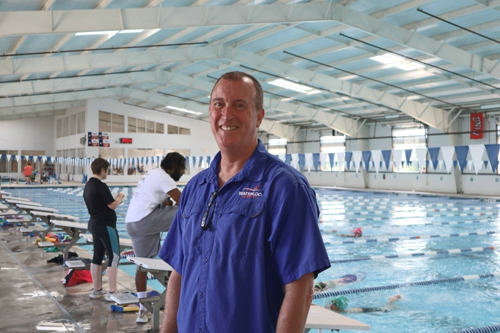 man posing for photo inside swim facility