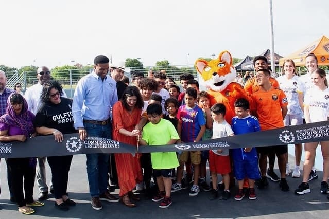 This is a photo of a ribbon-cutting ceremony for the new soccer pitches on May 30. 