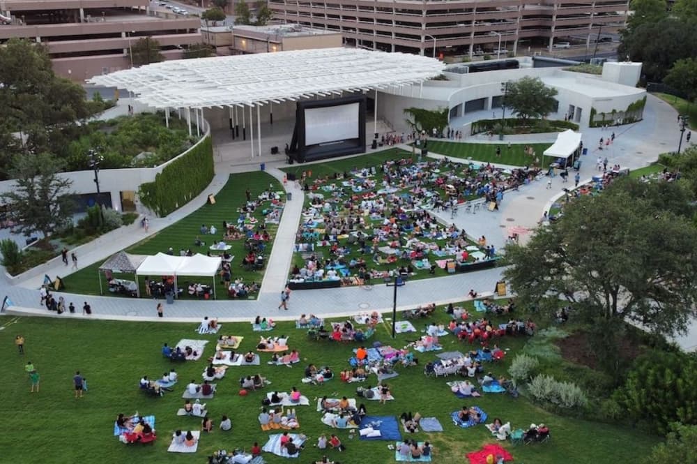 a crowd gathers outside of the Moody Amphitheater