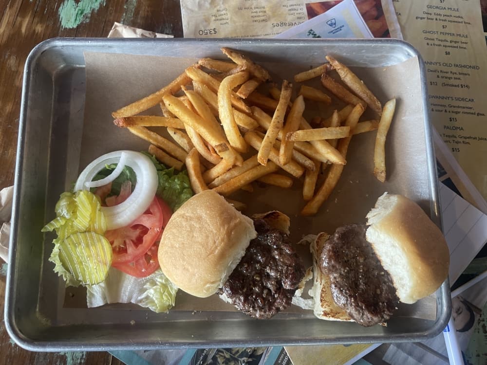 A photo of two sliders with a side of french fries 