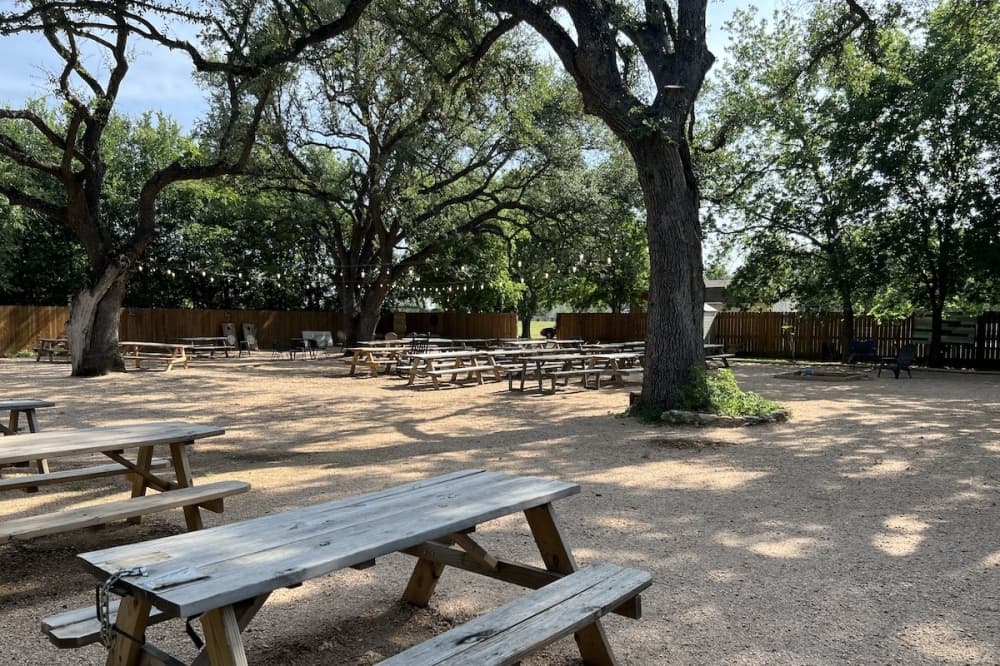 The barbecue joint features a large, canopied backyard with games, ax throwing and live music on the weekends. (Zacharia Washington/Community Impact)