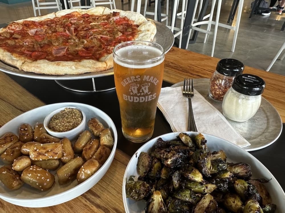 a table filled with food and a beer