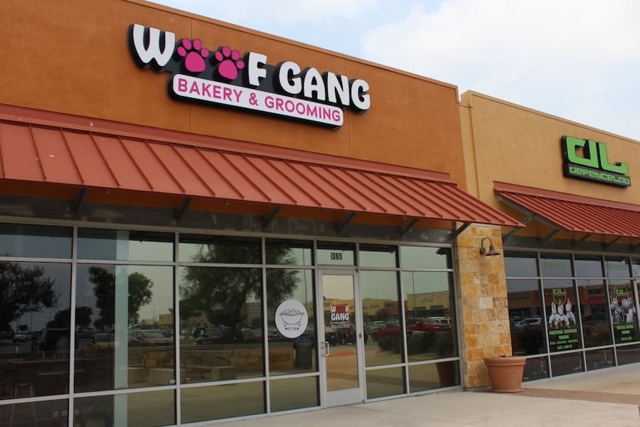 Outside of Woof Gang Bakery & Grooming in a strip mall