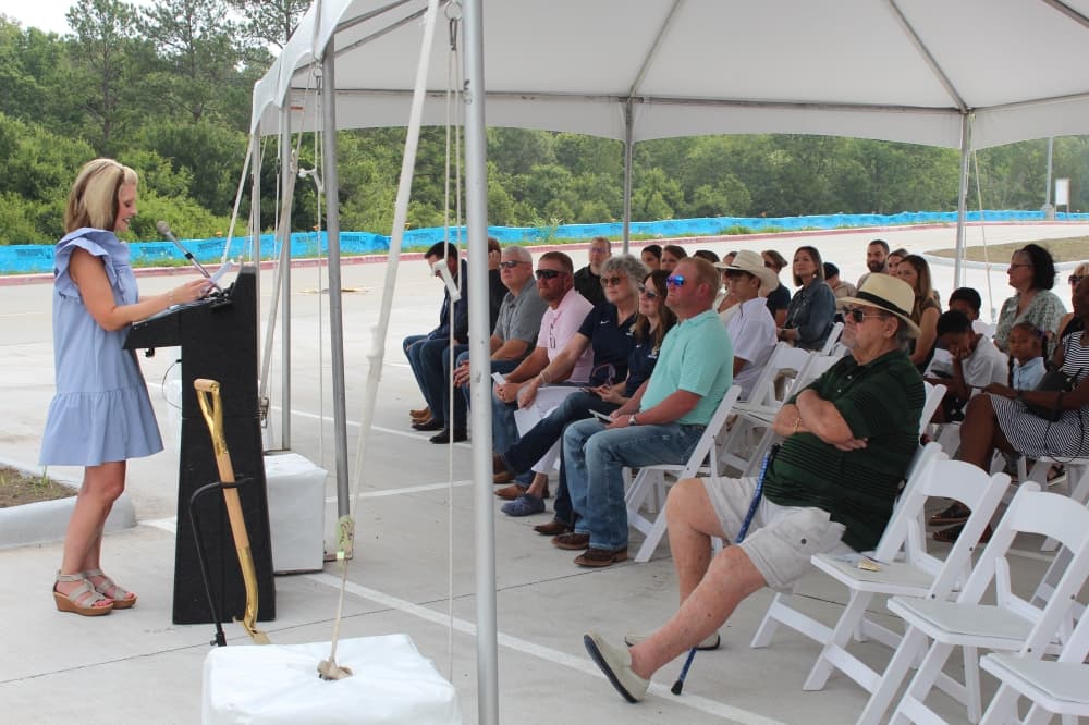 Carrie Fitzpatrick, assistant superintendent of elementary education, addresses attendees at the June 14 groundbreaking of Creekside Elementary School, located behind Lake Creek High School. (Anna Lotz/Community Impact)