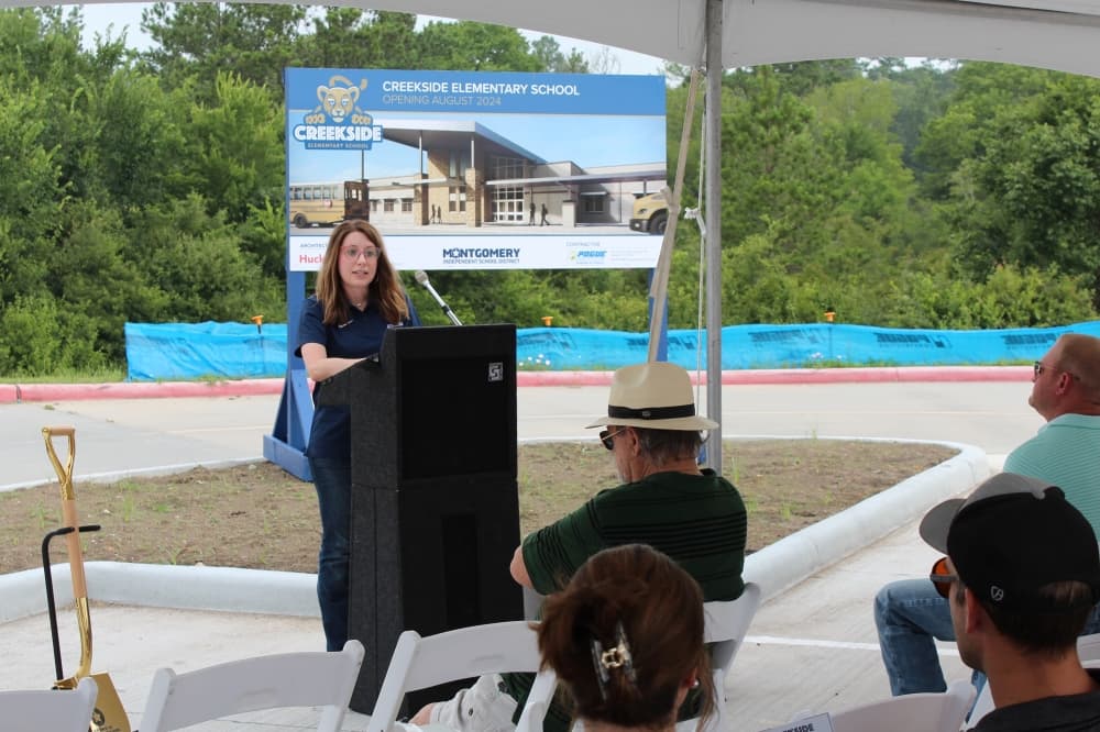 Board President Laurie Turner addresses attendees at the June 14 groundbreaking of Creekside Elementary School, located behind Lake Creek High School. (Anna Lotz/Community Impact)