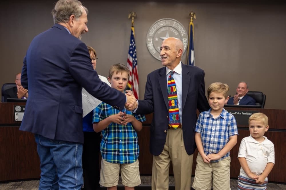Former U.S. Rep. Ted Poe administers the oath of office to Board President Robert Scarfo during the June 13 board meeting