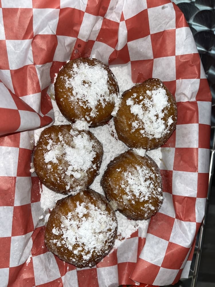 OMG Buns ($4.49) are served in honey and powdered sugar. (Peyton MacKenzie/Community Impact)