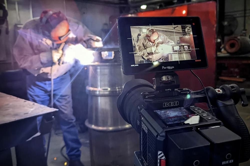 view through camera screen of someone welding