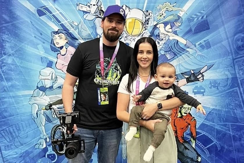 john truman poses with his family at a comicpalooza backdrop
