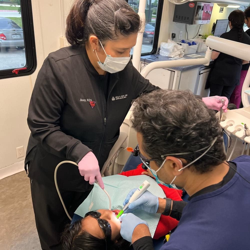 Dr. Neal Shah and dental assistant Jasmine Hernandez of Austin Dental Arts volunteer at the outreach van. (Courtesy Kids Tooth Team Outreach)