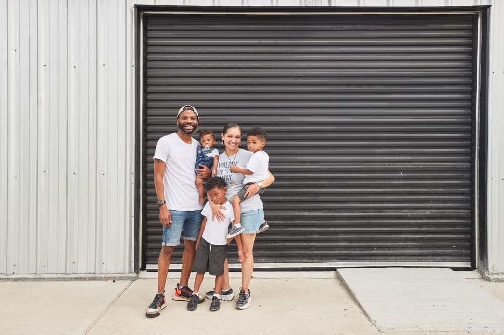 Tio and Kenzel Fallen pose with their children.