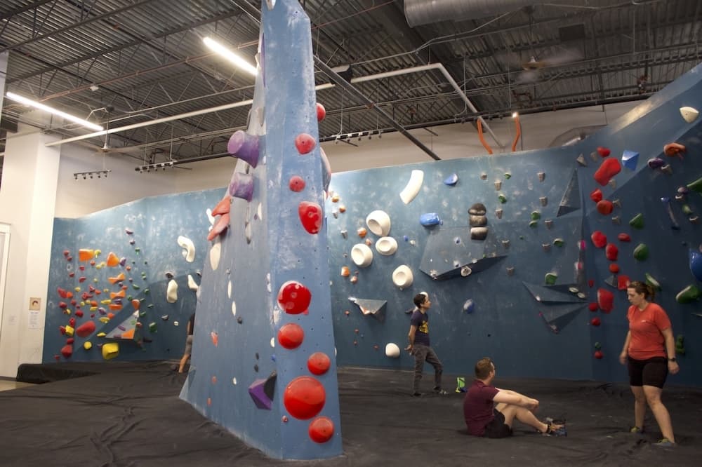 climbers take a break in front of a climbing terrain. 