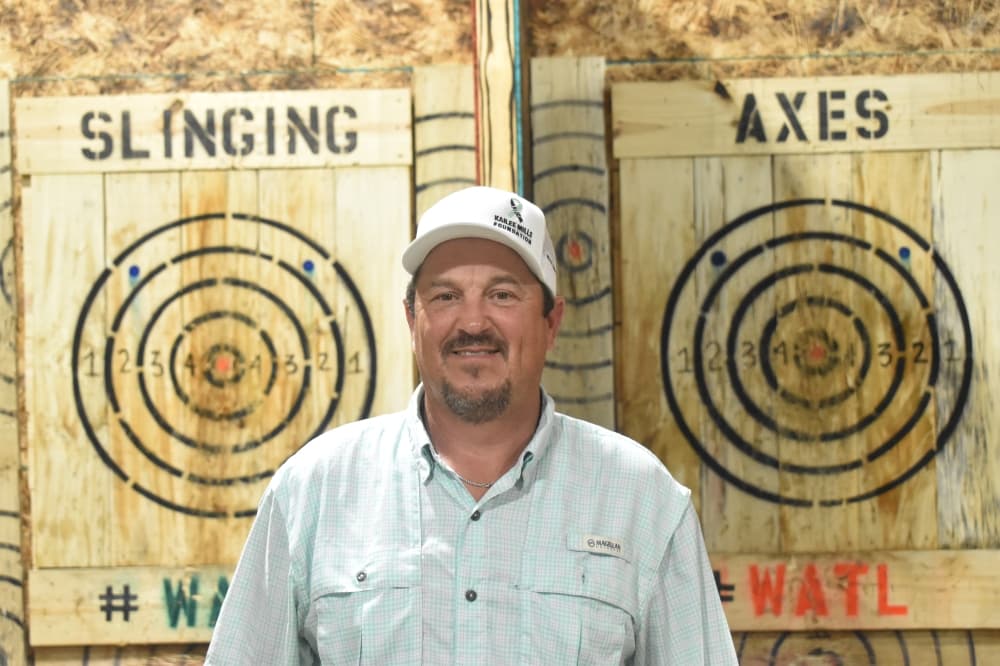 Dennis McCorvy, the owner of Slinging Axes, said he never threw an ax before opening his business. (Lizzy Spangler/Community Impact)