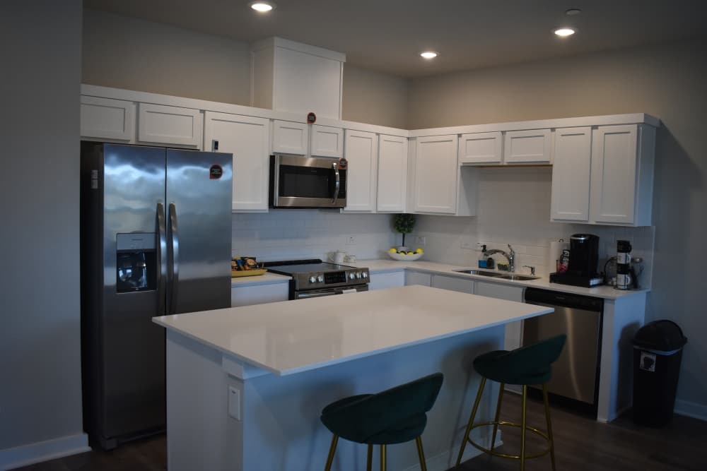 A kitchen, cabinets and kitchen island in a model home.