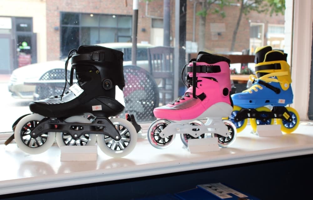three roller blades in a storefront window