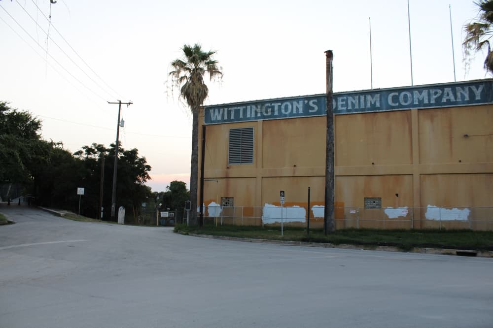 River Mill will take the site of the Mission Valley Mills built in 1921—according to the Comal Appraisal District—and transform it into a modern mixed-use facility. Wittington's Denim Company was painted on the building for the filming of the fifth season of "Fear the Walking Dead." (Eric Weilbacher/Community Impact)
