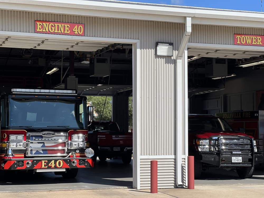 fire truck next to a fire engine in truck bay 